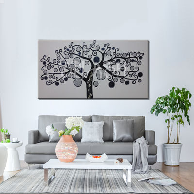 Tree of Life painting in silver colors on white and black painted trunk. 
